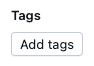 Add tags button in Unity Catalog model version UI.