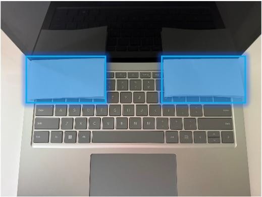 Screenshot that shows printer paper placed over hinge zones protecting screw holes.