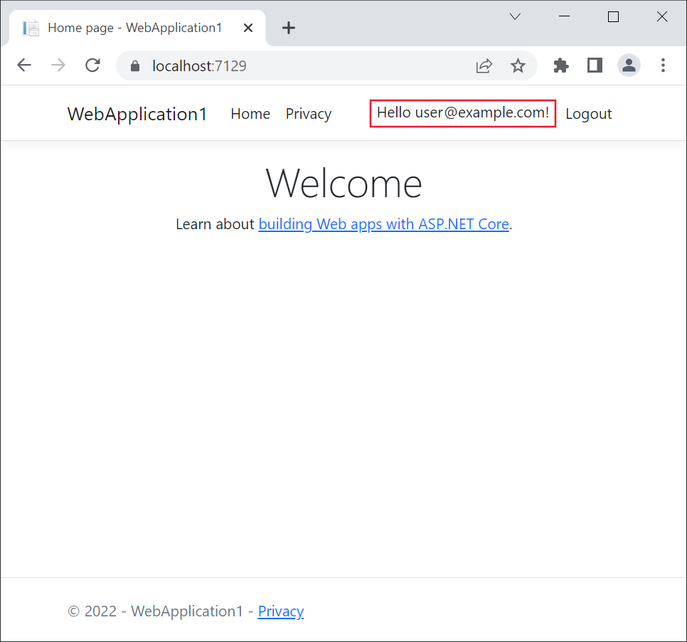 Microsoft Edge で Web アプリケーションが開きます。Register リンクは、Hello user@example.com! というテキストに置き換えられます。