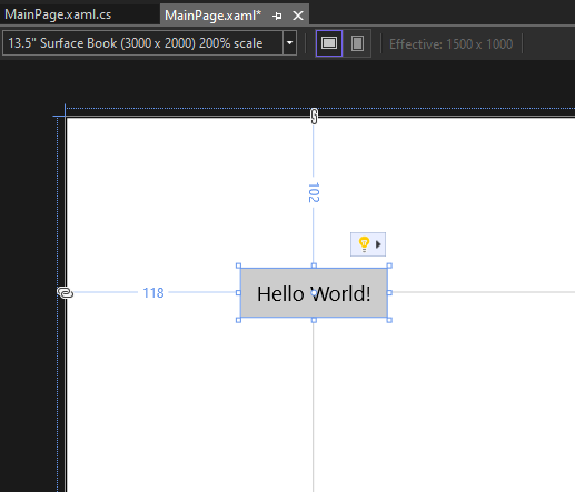 屏幕截图，显示 XAML 设计器画布上的按钮控件，按钮标签已更改为 Hello World！